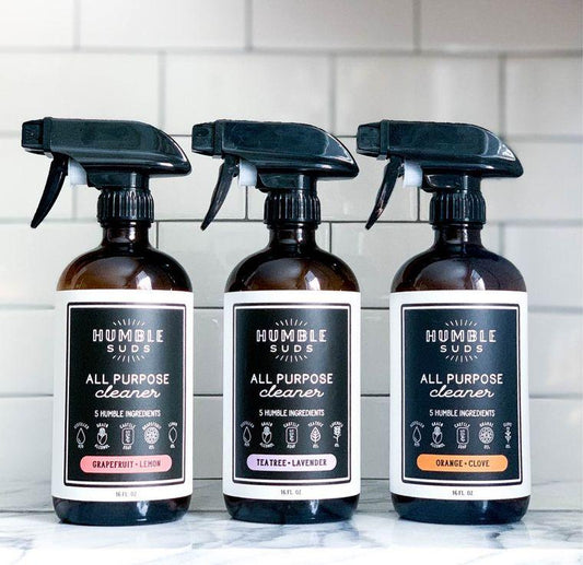 Three brown bottles of all purpose cleaner. Spray to remove bottle top, squeeze trigger to spray, twist tip to close. Tile background.