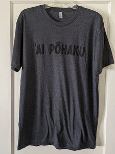 Soft lightweight heather charcoal men's tee with 'AI PŌHAKU in black ink on the chest, displayed on a hanger