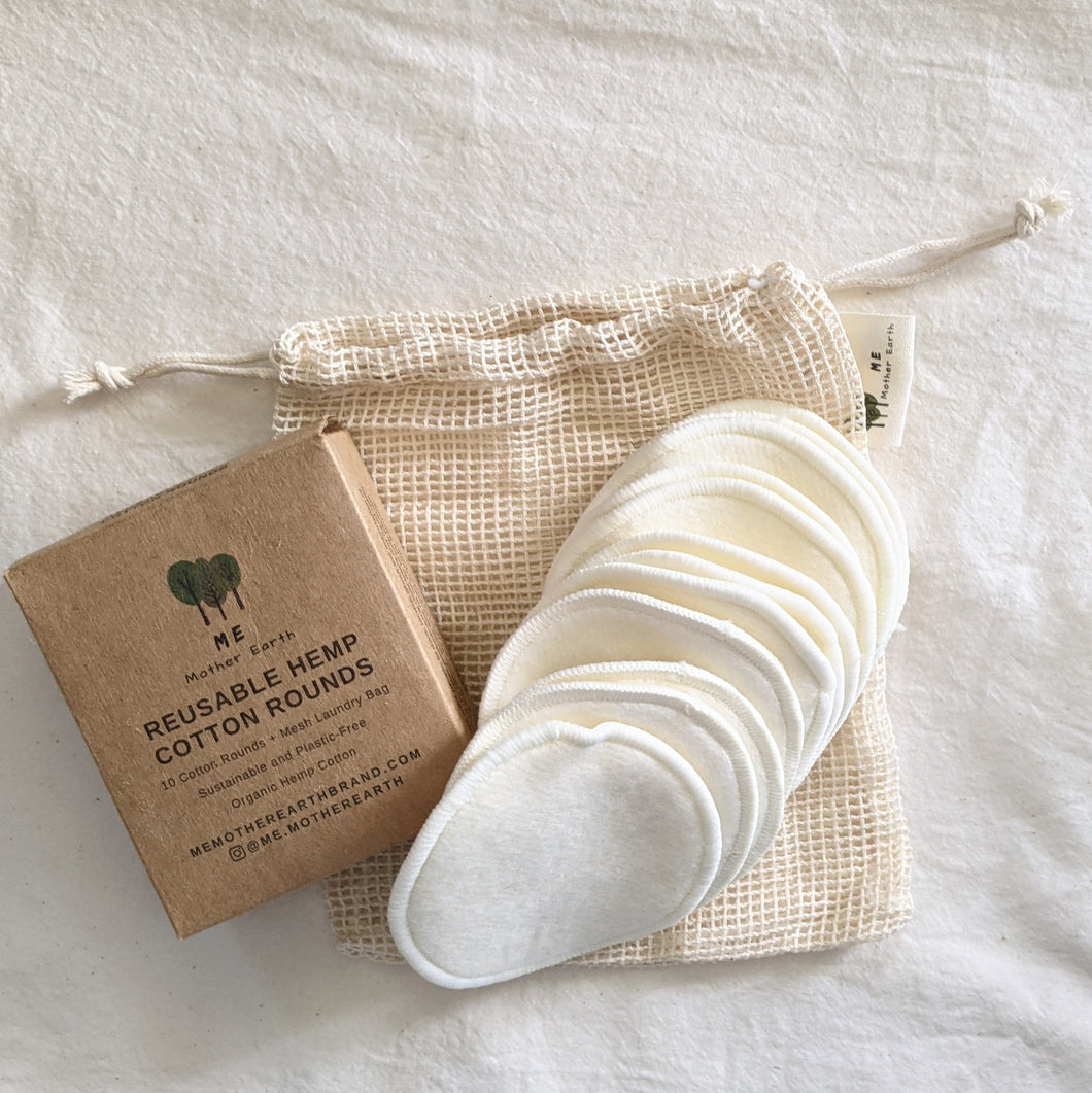 Ten natural-colored reusable cotton rounds made with hemp and cotton on a mesh cotton laundry bag and craft cardboard box